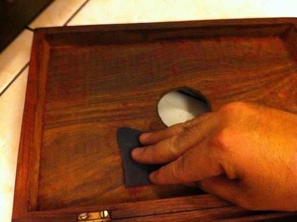 11. With the lining removed, proceed to sandpaper away all traces of glue and lining lint with a 600-grit sandpaper. Fold the sandpaper in half and work into the four edges of the compartment as well.