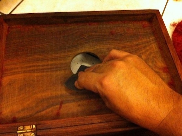 12. Work the sandpaper around the edge of the hole that was just made. Finish the interior surface with a 1000-grit sandpaper. 